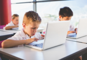 child works on school laptop