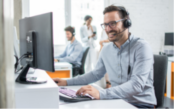 man works at desktop with headset