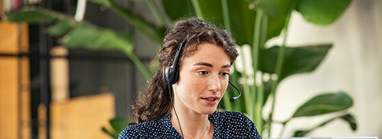 IT support team member speaking through a telephone headset.