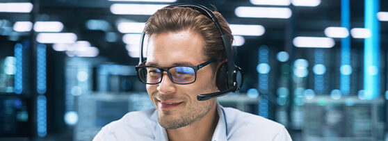 IT support team member talking to a customer via a telephone headset.